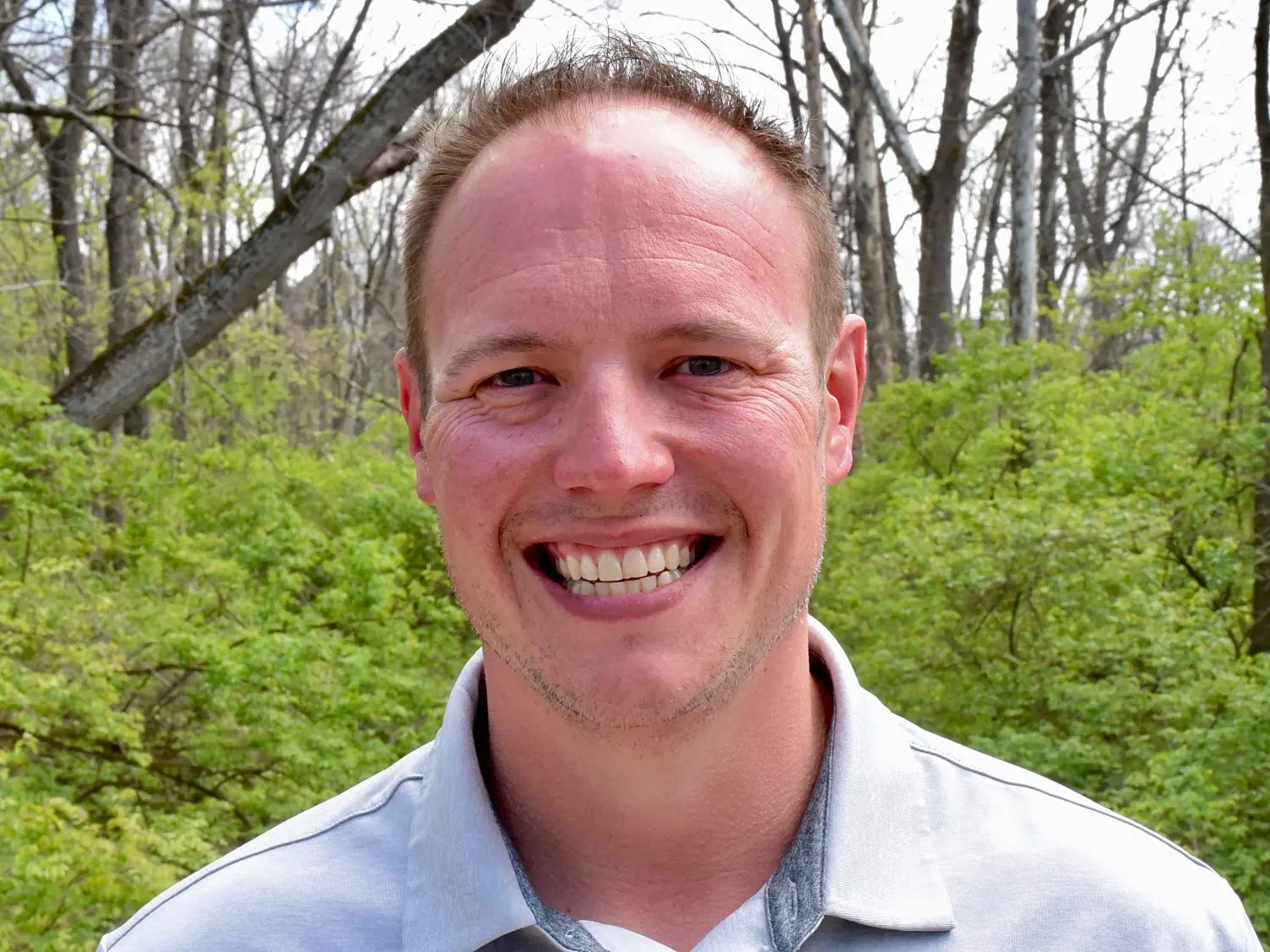 Close-up professional headshot of owner Bryan Woods at Summit in Cincinnati, OH, smiling outdoors.