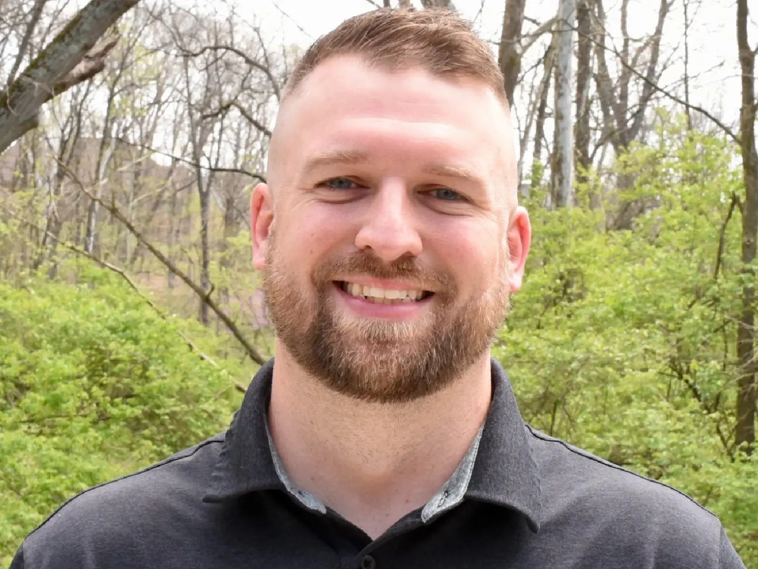 Close-up professional headshot of Tony Nuss at Summit in Cincinnati, OH, smiling outdoors.